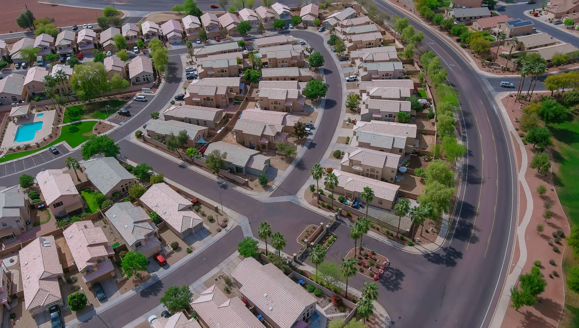 Aerial view of a Phoenix Valley neighborhood of tile-roof homes