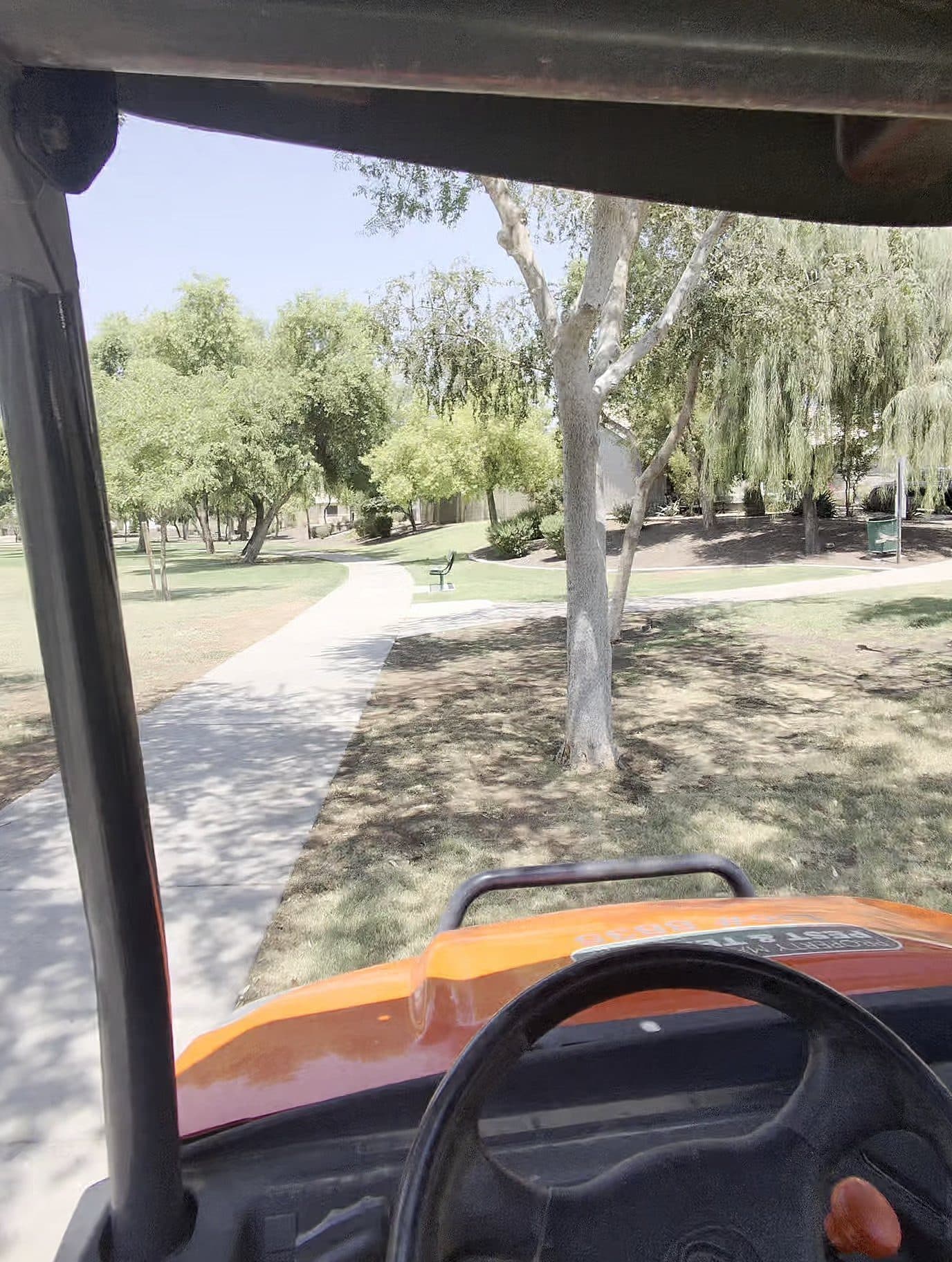 Service utility vehicle driving an HOA greenbelt